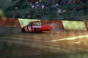 Bill Collins’ Chevy is done for the race and crawls out of turn 4.