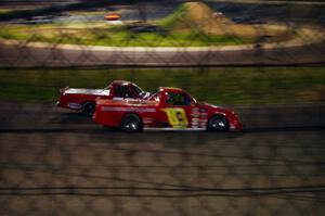 Andy Jirik’s Chevy and Jerry Wood’s Chevy side-by-side through turns 3 and 4