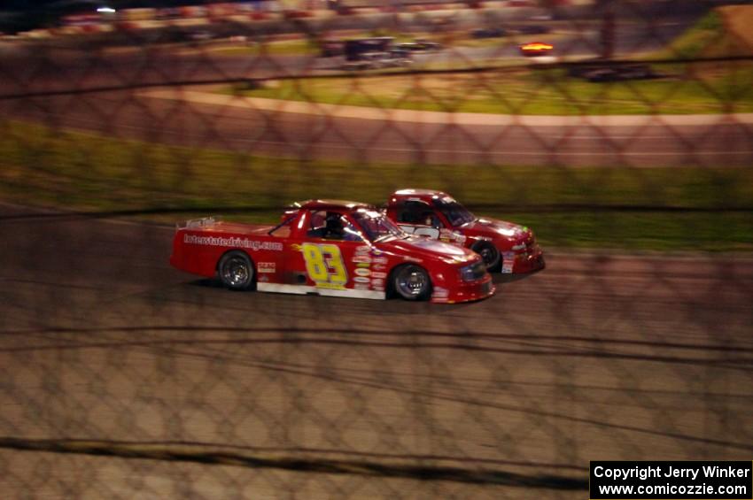 Andy Jirik’s Chevy and Jerry Wood’s Chevy side-by-side through turns 3 and 4