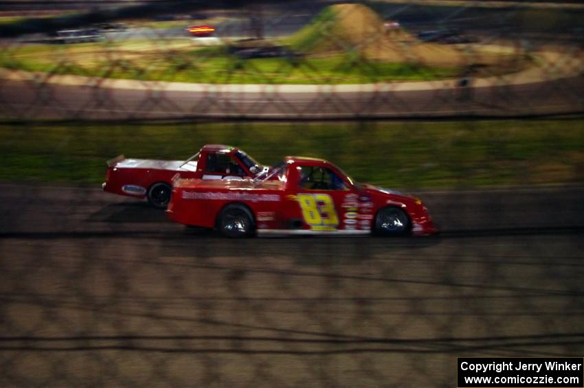 Andy Jirik’s Chevy and Jerry Wood’s Chevy side-by-side through turns 3 and 4