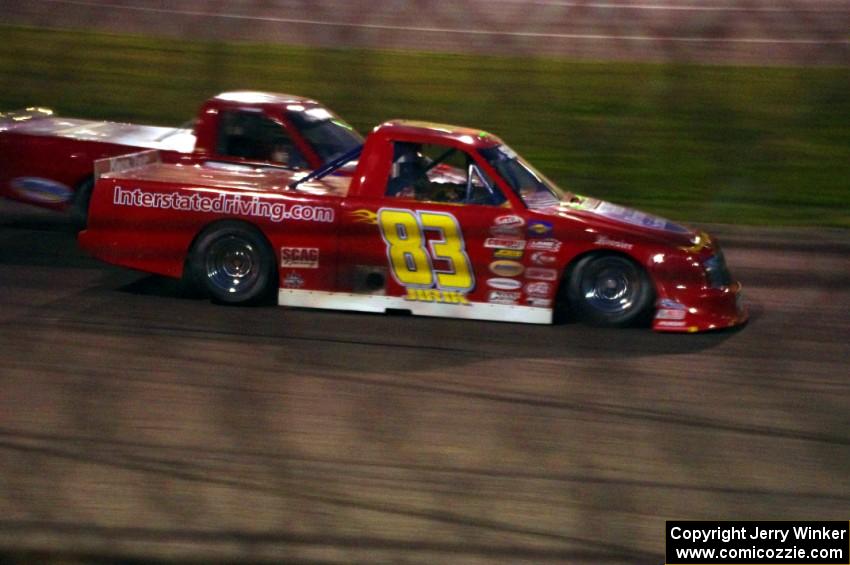 Andy Jirik’s Chevy and Jerry Wood’s Chevy side-by-side through turns 3 and 4