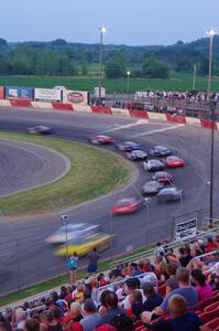 Fans watching cars through turn 1