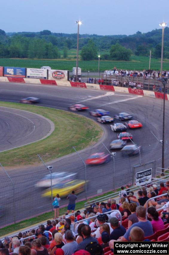 Fans watching cars through turn 1