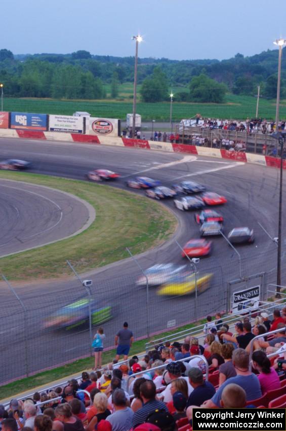 Fans watching cars through turn 1