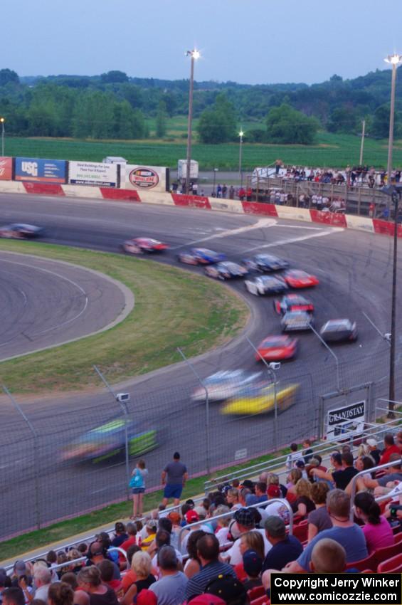 Fans watching cars through turn 1