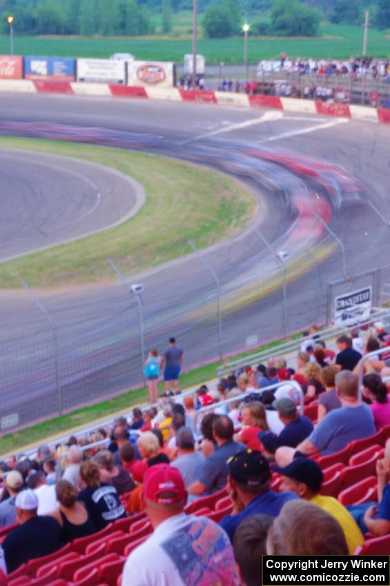 Fans watching cars through turn 1