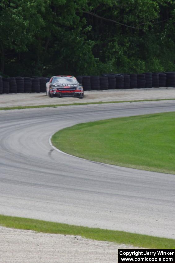 Jason Leffler's Chevy Impala in the gravel trap on the outside of the carousel