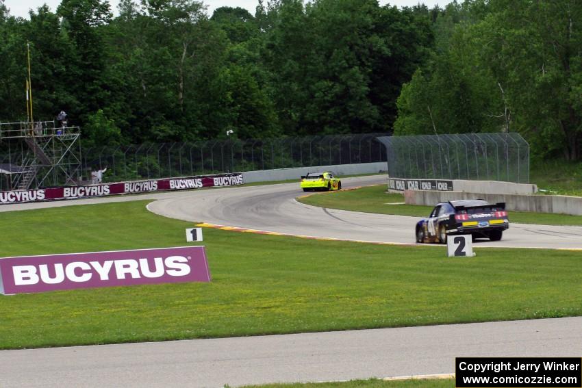 Max Papis' Chevy Impala and Doug Harrington's Ford Mustang at the kink