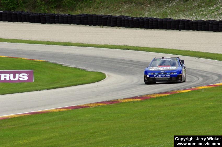 Doug Harrington's Ford Mustang exits the carousel