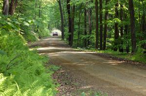 The Andrew Comrie-Picard / Marc Goldfarb Mitsubishi Lancer Evo 9 blasts down a high-speed straight.