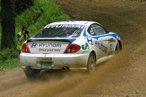 Pete Kuncis snaps a shot of the Paul Choiniere / Jeffrey Becker Hyundai Tiburon at a hairpin on SS3.