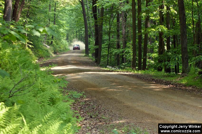 The Andrew Comrie-Picard / Marc Goldfarb Mitsubishi Lancer Evo 9 blasts down a high-speed straight.