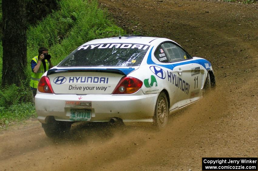 Pete Kuncis snaps a shot of the Paul Choiniere / Jeffrey Becker Hyundai Tiburon at a hairpin on SS3.