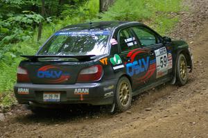 The Pat Moro / Mike Rossey Subaru WRX throws gravel while coming out of a hairpin on SS3.