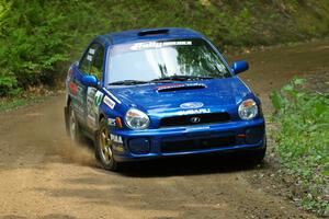 Travis Hanson / Terry Hanson at a hairpin on SS3 in their Subaru WRX.