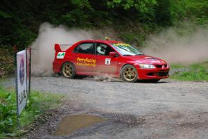 Bruce Perry drove the 0 car, a Mitsubishi Lancer Evo 8, for the day. The car is seen at a hairpin near the finish of SS6.