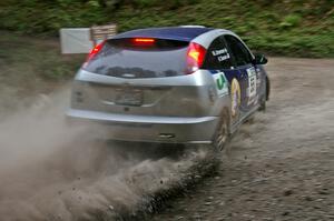 Kyle Sarasin / Mikael Johansson	take a perfect line at a hairpin on SS6 in their Ford Focus SVT.