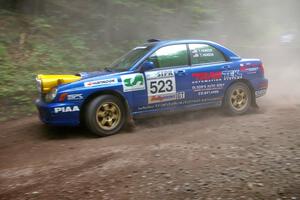 Travis Hanson / Terry Hanson go wide at the exit of a hairpin on SS6 in their Subaru WRX.