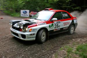 Justin Pritchard / Kim DeMotte Subaru WRX at a hairpin on SS6.