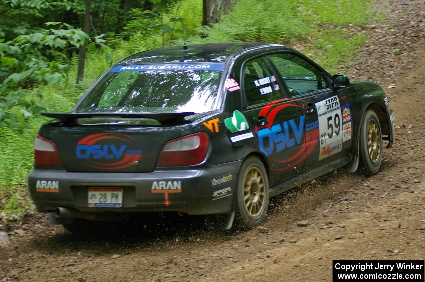 The Pat Moro / Mike Rossey Subaru WRX throws gravel while coming out of a hairpin on SS3.