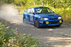 Dmitri Kishkarev / Hugh Hutchinson Mitsubishi Lancer Evo IV rockets down a straight on the practice stage.