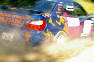 Tim Penasack / Scott Putnam drift through a fast left-hander in their Subaru WRX.