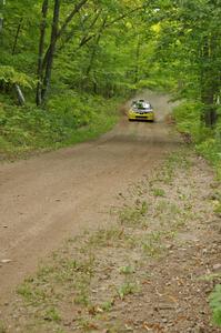 The Tanner Foust / Chrissie Beavis Subaru WRX STi rockets through a series of fast corners on the practice stage.