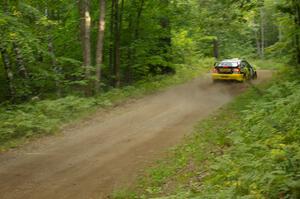 The Andy Pinker / Robbie Durant	Subaru WRX STi sets up for a fast downhill left-hander on the practice stage.