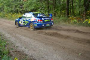 The Travis Pastrana / Christian Edstrom Subaru WRX STi hits the gas coming out of a 90-left on the practice stage.