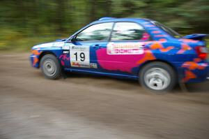 Tim Penasack / Scott Putnam power out of a 90-left in their Subaru WRX.