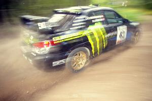Ken Block / Alex Gelsomino Subaru WRX STi blasts gravel while taking a hard left-hander on the practice stage.