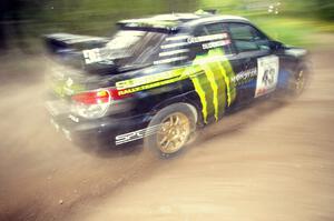 Ken Block / Alex Gelsomino Subaru WRX STi blasts gravel while taking a hard left-hander on the practice stage.