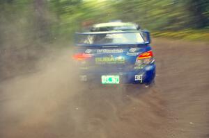 Travis Pastrana / Christian Edstrom Subaru WRX STi blasts gravel while taking a hard left-hander on the practice stage.