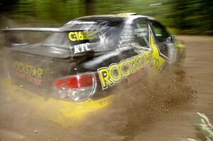 The Andy Pinker / Robbie Durant Subaru Impreza WRX STi sprays gravel on the press stage.