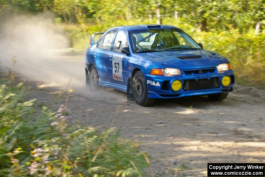 Dmitri Kishkarev / Hugh Hutchinson Mitsubishi Lancer Evo IV rockets down a straight on the practice stage.