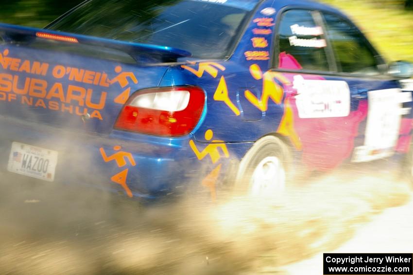 Tim Penasack / Scott Putnam drift through a fast left-hander in their Subaru WRX.