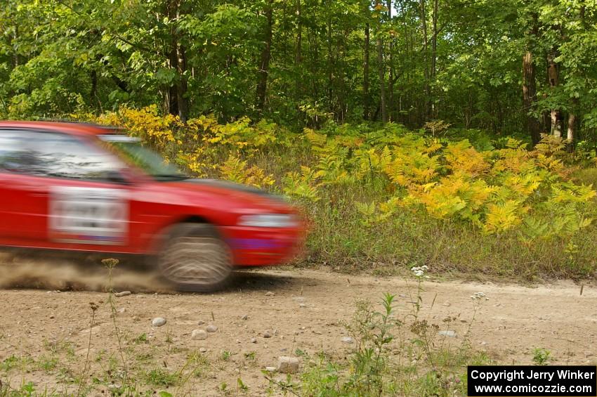 The Dennis Martin / Kim DeMotte Mitsubishi Evo 4 blasts past ferns that were turning yellow prematurely from the dry summer.