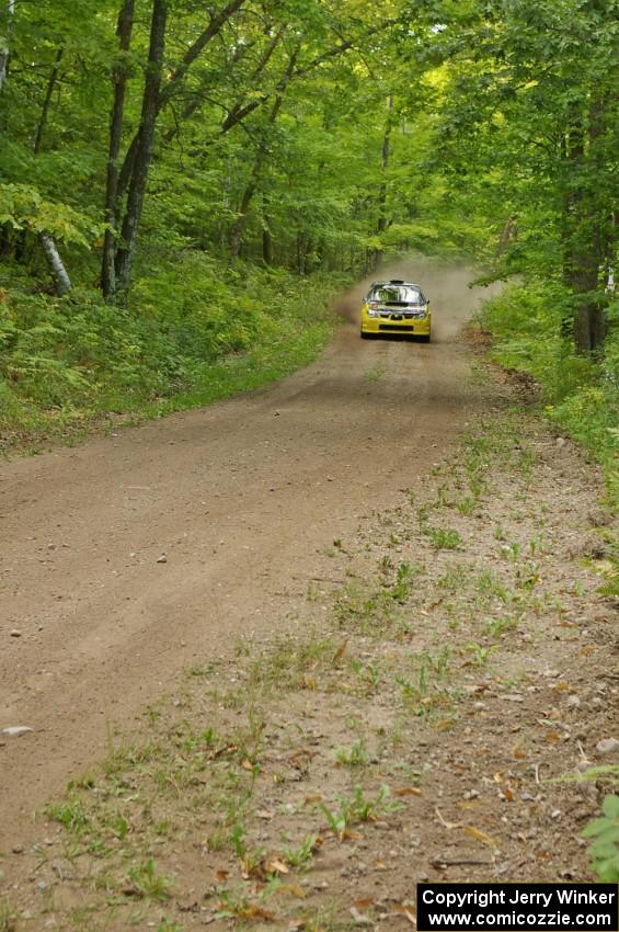 The Tanner Foust / Chrissie Beavis Subaru WRX STi rockets through a series of fast corners on the practice stage.