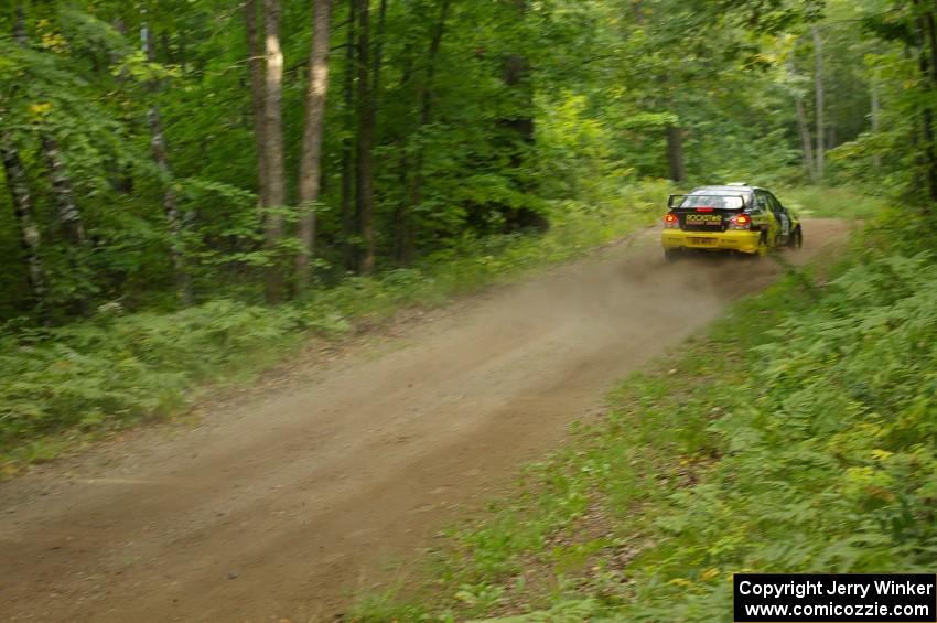 The Andy Pinker / Robbie Durant	Subaru WRX STi sets up for a fast downhill left-hander on the practice stage.