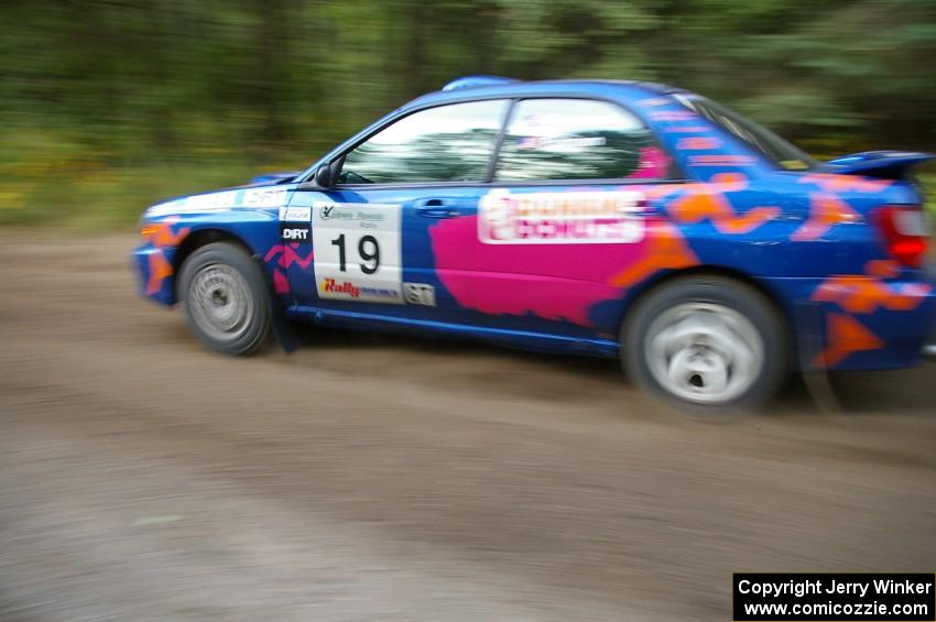 Tim Penasack / Scott Putnam power out of a 90-left in their Subaru WRX.