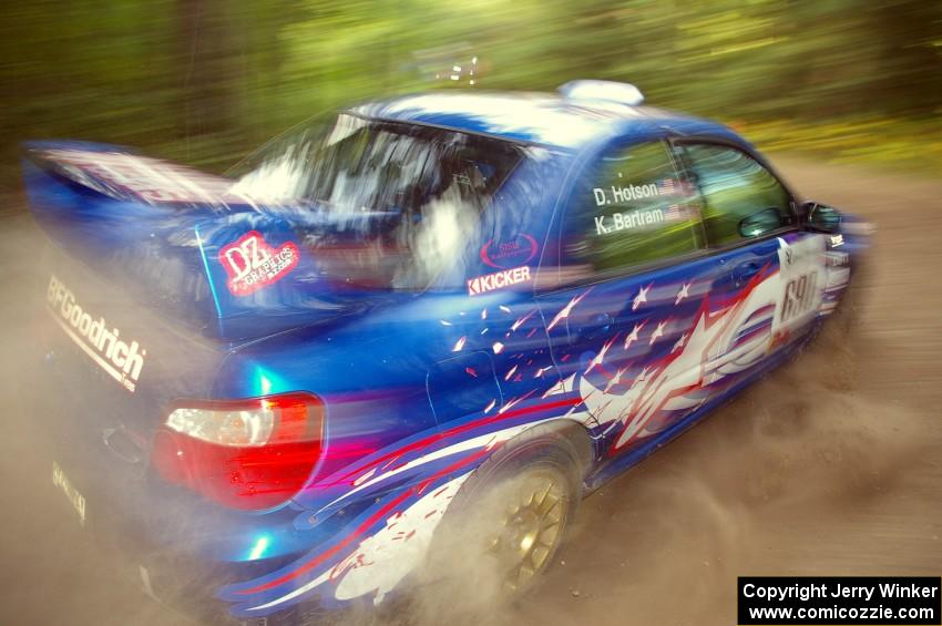 Kenny Bartram / Dennis Hotson Subaru WRX STi blasts gravel while taking a hard left-hander on the practice stage.