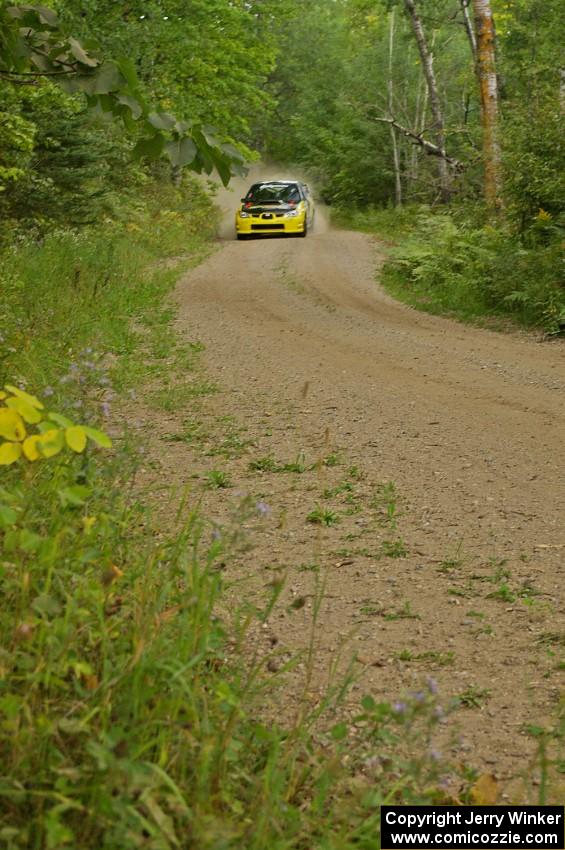 Tanner Foust / Chrissie Beavis Subaru WRX STi flies through a series of fast corners on the press stage.