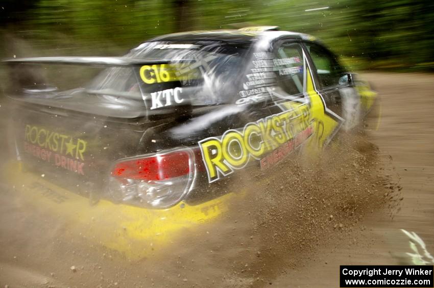 The Andy Pinker / Robbie Durant Subaru Impreza WRX STi sprays gravel on the press stage.