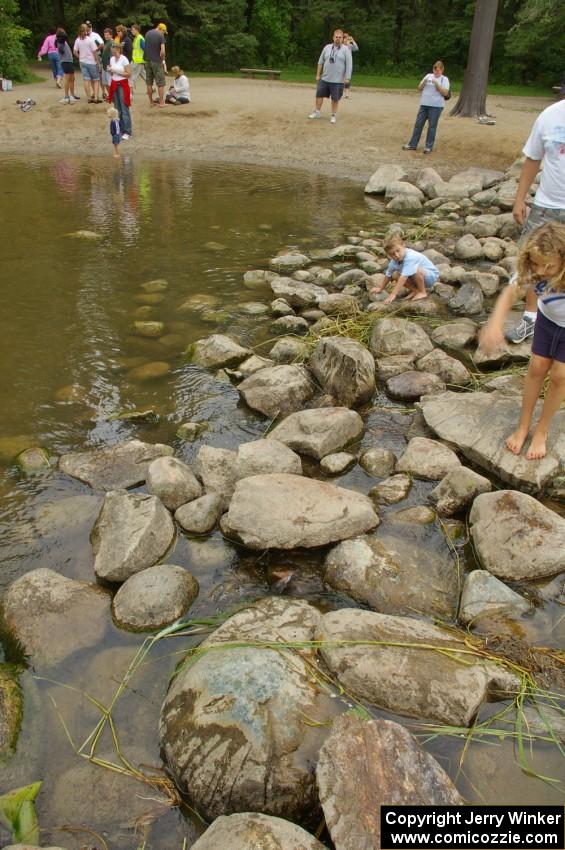 People walk across the Mississsippi River at its start at Lake Itasca.