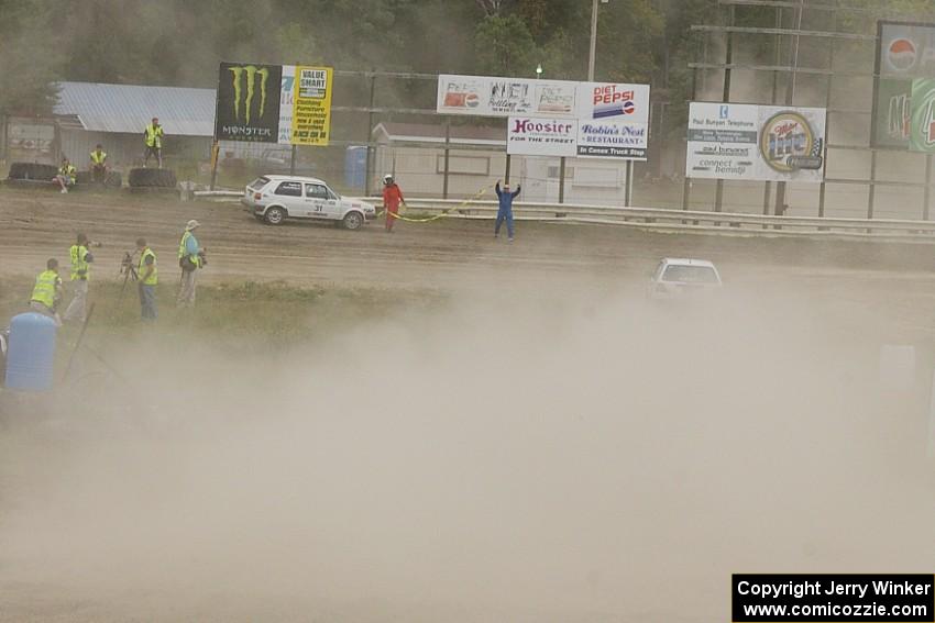 Chris Duplessis / Martin Headland VW GTI goes past the stranded Michel Hoche-Mong / Sameer Parekh VW GTI.