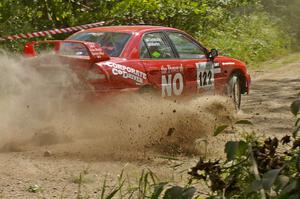 Dennis Martin / Kim DeMotte sling gravel on SS9 in their Mitsubishi Lancer Evo IV.