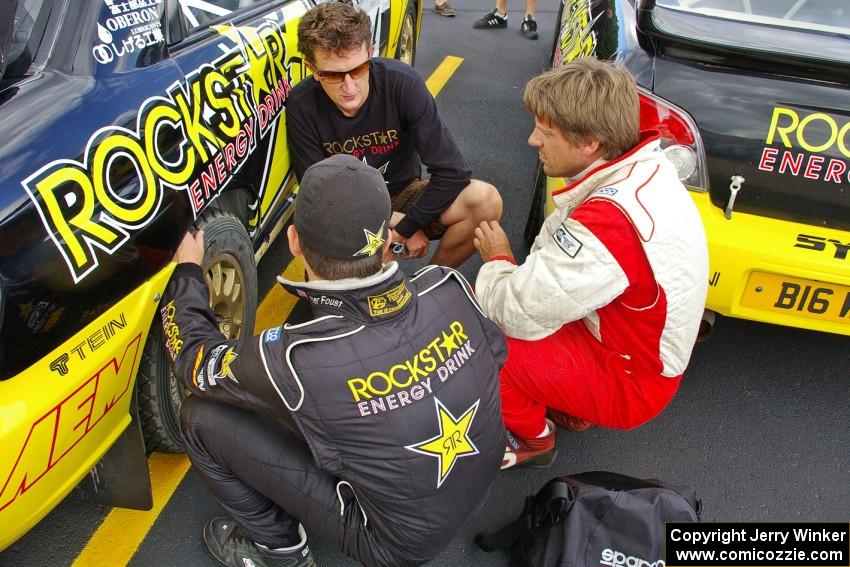 Tanner Foust (back to the camera), Andy Pinker, and Stephan Verdier talk strategy prior to day two of the rally (1).