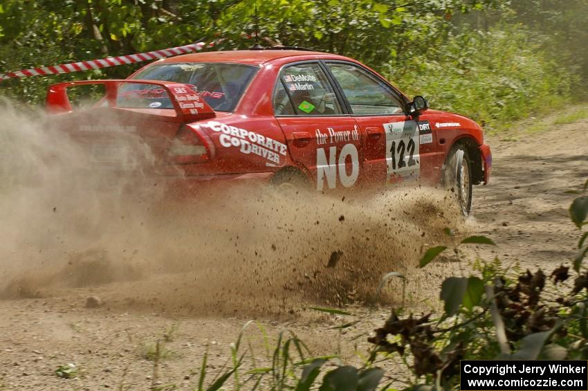 Dennis Martin / Kim DeMotte sling gravel on SS9 in their Mitsubishi Lancer Evo IV.