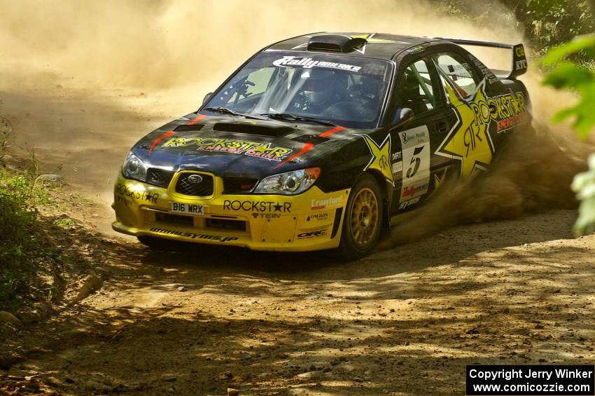 Andy Pinker / Robbie Durant Subaru WRX STi at a hard uphill right on SS12.