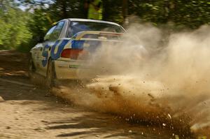 Henry Krolikowski / Cindy Krolikowski Subaru Impreza slings gravel at a 90-right on SS12.